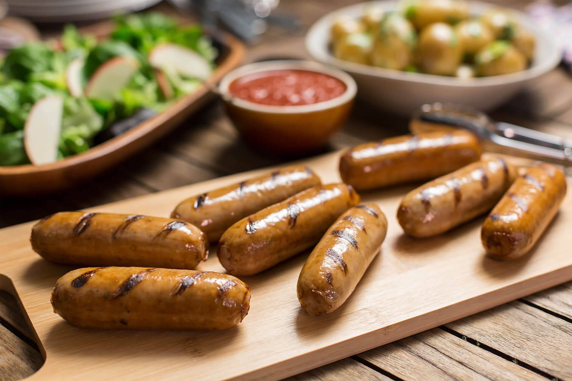 cooked precooked sausages on a board