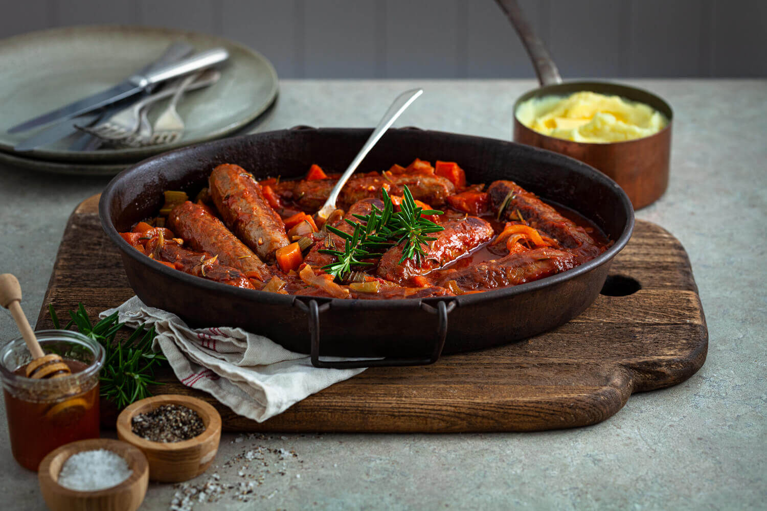 Honey and rosemary lamb sausages in a tomato braise