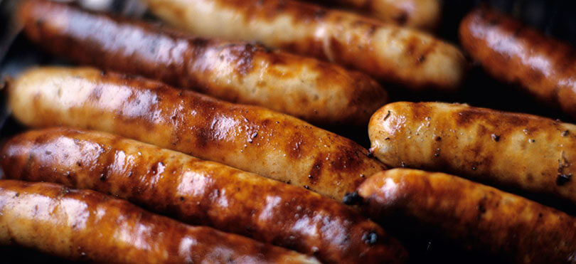 fresh sausages cooking on the bbq