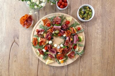 christmas kebab wreath on a circular chopping board featuring hellers salami, ham and delicious cheeses